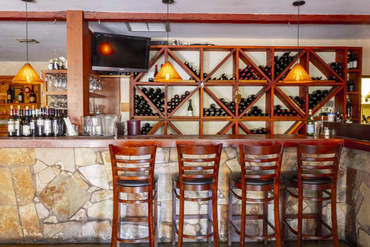 Caffe Pinguini bar with wine rack, wine bottles